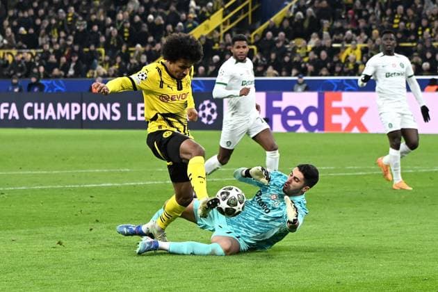 Karim Adeyemi Borussia Dortmund and goalkeeper Rui Silva Sporting Lisbon battle for the ball during the UEFA Champions League 2024 25 League Play offs second leg match between Borussia Dortmund and Sporting Lisbon, SIGNAL IDUNA PARK on February 19, 2025 in Dortmund, Germany, Germany Photo by Ralf Treese DeFodi Images Karim Adeyemi Borussia Dortmund and goalkeeper Rui Silva Sporting Lisbon battle for the ball during the UEFA Champions League 2024 25 League Knockout Play off Second Leg match between Borussia Dortmund and Sporting Clube de Portugal at Signal Iduna Park on February 19, 2025 in Dortmund, Germany Photo by Ralf Treese DeFodi Images Defodi-521
