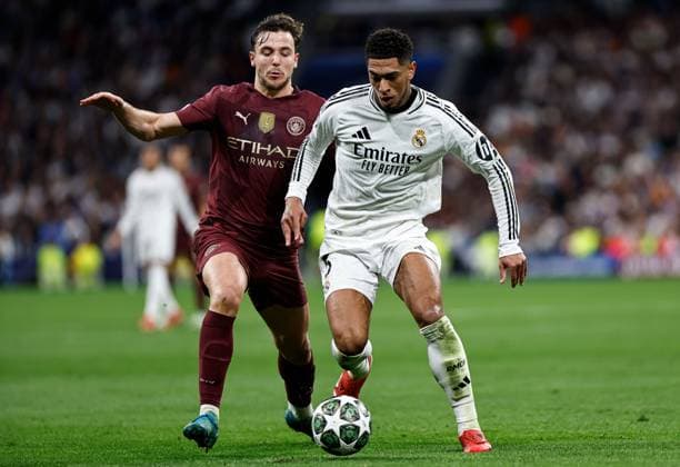 Nico of Manchester City battles with Jude Bellingham of Real Madrid Real Madrid v Manchester City, UEFA Champions League, Knockout Round Play-offs, Second Leg, Football, Santiago BernaboÆ?Ã?Æ?o Ã? u, Madrid, Spain - 19 Feb 2025 EDITORIAL USE ONLY No use with unauthorised audio, video, data, fixture lists, club league logos or live services. Online in-match use limited to 120 images, no video emulation. No use in betting, games or single club league player publications. Copyright: xRubenxAlbarran Shutterstockx 15137179ag