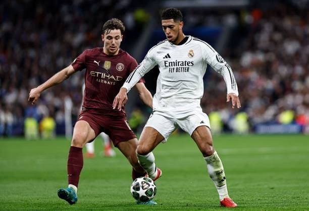 Nico of Manchester City battles with Jude Bellingham of Real Madrid Real Madrid v Manchester City, UEFA Champions League, Knockout Round Play-offs, Second Leg, Football, Santiago BernaboÆ?Ã?Æ?o Ã? u, Madrid, Spain - 19 Feb 2025 EDITORIAL USE ONLY No use with unauthorised audio, video, data, fixture lists, club league logos or live services. Online in-match use limited to 120 images, no video emulation. No use in betting, games or single club league player publications. Copyright: xRubenxAlbarran Shutterstockx 15137179af