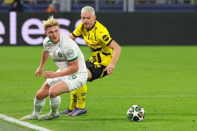 (250220) -- DORTMUND, Feb. 20, 2025 -- Julian Ryerson (R) of Borussia Dortmund vies with Conrad Harder of Sporting CP during the UEFA Champions League knockout phase play-off second leg football match between Borussia Dortmund and Sporting CP in Dortmund, Germany, Feb. 19, 2025. (Photo by Xinhua) (SP)GERMANY-DORTMUND-FOOTBALL-UEFA CHAMPIONS LEAGUE-DORTMUND VS SPORTING CP JoachimxBywaletz 