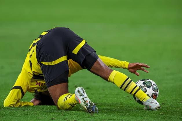 19 02 2025, Football, UEFA Champions League, Borussia Dortmund Sporting Lisbon, Signal Iduna Park, Knockout phase play offs, Season 2024 2025 Karim Adeyemi BVB 27 lies on the pitch and reaches for the ball North Rhine-Westphalia Germany