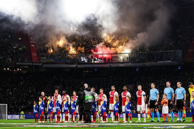 2025-02-20 AFC Ajax v R. Union Saint-Gilloise - UEFA Europa League 2024 25 League Knockout Play-off Second Leg AMSTERDAM, NETHERLANDS - FEBRUARY 20: goalkeeper Remko Pasveer of AFC Ajax, Christian Rasmussen of AFC Ajax, Josip Sutalo of AFC Ajax, Jorthy Mokio of AFC Ajax, Daniele Rugani of AFC Ajax, Steven Berghuis of AFC Ajax, Lucas Rosa of AFC Ajax, Davy Klaassen of AFC Ajax, Jorrel Hato of AFC Ajax, Oliver Valaker Edvardsen of AFC Ajax, Kian Fitz-Jim of AFC Ajax with fireworks of R. Union Saint-Gilloise in the background during the UEFA Europa League 2024 25 League Knockout Play-off Second Leg match between AFC Ajax and R. Union Saint-Gilloise at Johan Cruijff Arena on February 20, 2025 in Amsterdam, Netherlands. Amsterdam Johan Cruijff Arena Netherlands Content not available for redistribution in The Netherlands directly or indirectly through any third parties. Copyright: xBenxGalx