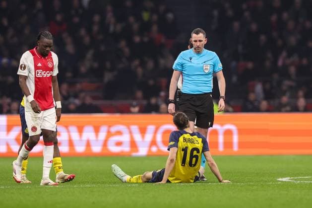 2025-02-20 AFC Ajax v R. Union Saint-Gilloise - UEFA Europa League 2024 25 League Knockout Play-off Second Leg AMSTERDAM, NETHERLANDS - FEBRUARY 20: Christian Burgess of R. Union Saint-Gilloise sits on the ground with an injury during the UEFA Europa League 2024 25 League Knockout Play-off Second Leg match between AFC Ajax and R. Union Saint-Gilloise at Johan Cruijff Arena on February 20, 2025 in Amsterdam, Netherlands. Amsterdam Johan Cruijff Arena Netherlands Content not available for redistribution in The Netherlands directly or indirectly through any third parties. Copyright: xBenxGalx
