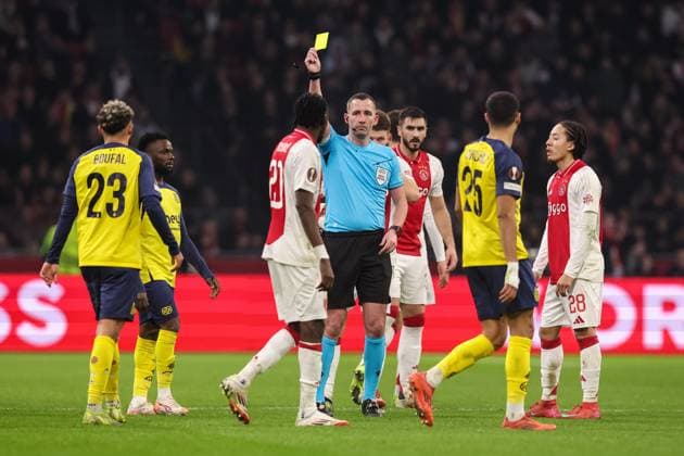 2025-02-20 AFC Ajax v R. Union Saint-Gilloise - UEFA Europa League 2024 25 League Knockout Play-off Second Leg AMSTERDAM, NETHERLANDS - FEBRUARY 20: referee Chris Kavanagh shows a yellow card to Sofiane Boufal of R. Union Saint-Gilloise during the UEFA Europa League 2024 25 League Knockout Play-off Second Leg match between AFC Ajax and R. Union Saint-Gilloise at Johan Cruijff Arena on February 20, 2025 in Amsterdam, Netherlands. Amsterdam Johan Cruijff Arena Netherlands Content not available for redistribution in The Netherlands directly or indirectly through any third parties. Copyright: xBenxGalx