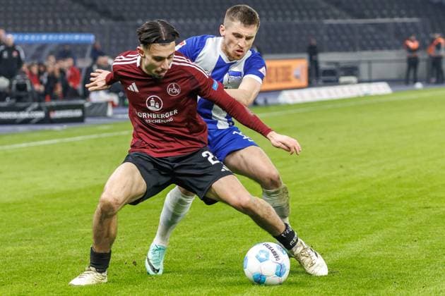 Berlin, 21 02 25, Soccer, 2 Bundesliga, Matchday 23, Hertha BSC 1 FC Nuernberg, Olympiastadion Berkay Yilmaz of FC Nuernberg l fights against Berlins Jonjoe Kenny r for the ball DFL regulations and DFB regulations prohibit any use of photographs as image sequences and or quasi video, Foto Andreas Gora Hertha BSC 1 FC Nuernberg