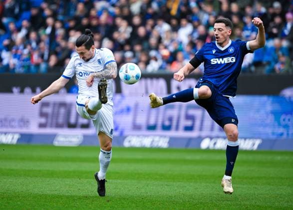 Baris Atik 1 FC Magdeburg and Nicolai Rapp Karlsruher SC battle for the ball during the 2 Bundesliga match between Karlsruher SC and 1 FC Magdeburg at BBBank Wildpark on February 22, 2025 in Karlsruhe, Germany, Germany Photo by Silas Schüller DeFodi Images Baris Atik 1 FC Magdeburg and Nicolai Rapp Karlsruher SC battle for the ball during the 2 Bundesliga match between Karlsruher SC and 1 FC Magdeburg at BBBank Wildpark on February 22, 2025 in Karlsruhe, Germany Photo by Silas Schüller DeFodi Images DFB DFL REGULATIONS PROHIBIT ANY USE OF PHOTOGRAPHS AS IMAGE SEQUENCES AND OR QUASI VIDEO Photo by Silas Schueller DeFodi Images