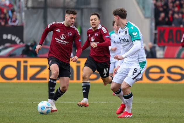 Stefanos Tzimas 1FC Nuernberg 9 in duel with Phil Neumann Hannover 96 5 , 1 FC Nuernberg vs Hannover 96, Soccer, 2 Bundesliga, 24 Matchday, 01 03 2025 DFB regulations prohibit any use of photographs as image sequences and or quasi video Nuernberg Bayern Germany Copyright: xkolbert-press MartinxAgüerax