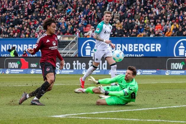 in duel, action, with Janis Antiste 28 1 FC Nuernberg , Ron Robert Zieler 1 Hannover 96 , 1 FC Nuernberg vs Hannover 96, Football, 2 Bundesliga, 24 Matchday, 01 03 2025 DFB regulations prohibit any use of photographs as image sequences and or quasi video Nuernberg Bayern Germany Copyright: xkolbert-press MartinxAgüerax
