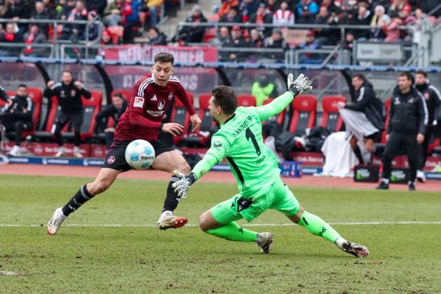 in duel, action, with Stefanos Tzimas 9 1 FC Nuernberg , Ron Robert Zieler 1 Hannover 96 , 1 FC Nuernberg vs Hannover 96, Soccer, 2 Bundesliga, 24 Matchday, 01 03 2025 DFB regulations prohibit any use of photographs as image sequences and or quasi video Nuernberg Bayern Germany Copyright: xkolbert-press MartinxAgüerax