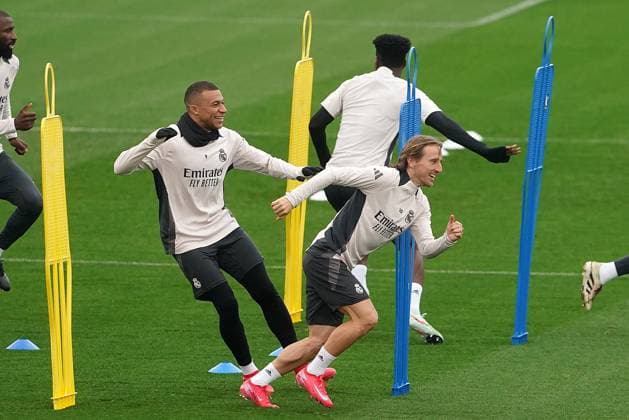Real Madrid CF s Kylian Mbappe (l) and Luka Modric during the training session prior to the first leg of the Champions League Round of 16 against Atletico de Madrid. March 3, 2025. (2025030351)