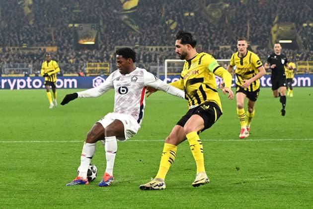 Jonathan David Lille OSC and Emre Can Borussia Dortmund battle for the ball during the UEFA Champions League 2024 25 Round of 16 First Leg match between Borussia Dortmund and LOSC Lille at Signal Iduna Park on March 4, 2025 in Dortmund, Germany Photo by Ralf Treese DeFodi Images