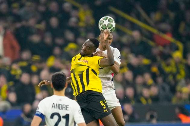 Serhou Guirassy Borussia Dortmund and Bafode Diakite LOSC Lille battle for the ball during the UEFA Champions League 2024 25 Round of 16 First Leg match between Borussia Dortmund and LOSC Lille at Signal Iduna Park on March 4, 2025 in Dortmund, Germany