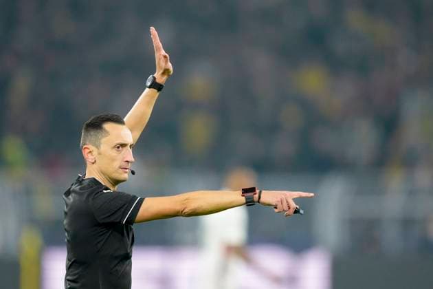 Referee Jose Maria Sanchez Martinez gestures during the UEFA Champions League 2024 25 Round of 16 First Leg match between Borussia Dortmund and LOSC Lille at Signal Iduna Park on March 4, 2025 in Dortmund, Germany