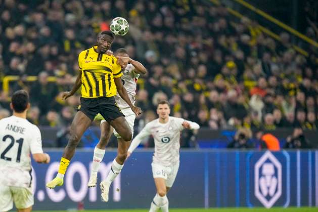 Serhou Guirassy Borussia Dortmund and Bafode Diakite LOSC Lille battle for the ball during the UEFA Champions League 2024 25 Round of 16 First Leg match between Borussia Dortmund and LOSC Lille at Signal Iduna Park on March 4, 2025 in Dortmund, Germany
