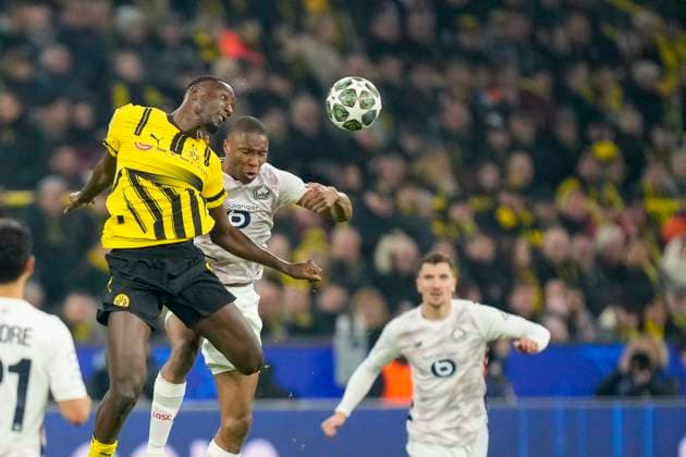Serhou Guirassy Borussia Dortmund and Bafode Diakite LOSC Lille battle for the ball during the UEFA Champions League 2024 25 Round of 16 First Leg match between Borussia Dortmund and LOSC Lille at Signal Iduna Park on March 4, 2025 in Dortmund, Germany
