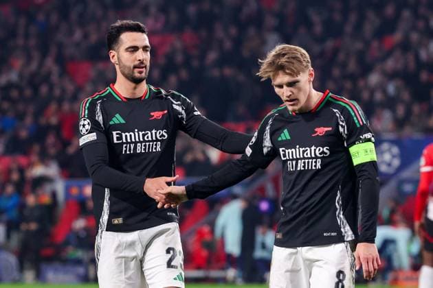 2025-03-04 PSV v Arsenal FC - UEFA Champions League 2024 25 Round of 16 First Leg EINDHOVEN, NETHERLANDS - MARCH 4: Martin Odegaard of Arsenal FC celebrates after scoring his teams sixth goal, Mikel Merino of Arsenal FC during the UEFA Champions League 2024 25 Round of 16 First Leg match between PSV and Arsenal FC at PSV Stadion on March 4, 2025 in Eindhoven, Netherlands. Eindhoven PSV Stadion Netherlands Content not available for redistribution in The Netherlands directly or indirectly through any third parties. Copyright: xBenxGalx