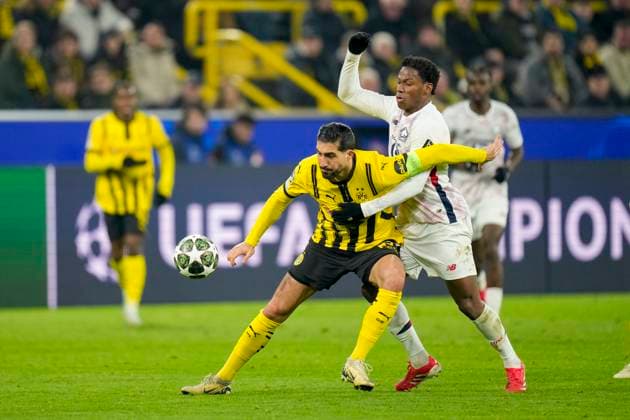 Emre Can Borussia Dortmund and Jonathan David LOSC Lille battle for the ball during the UEFA Champions League 2024 25 Round of 16 First Leg match between Borussia Dortmund and LOSC Lille at Signal Iduna Park on March 4, 2025 in Dortmund, Germany