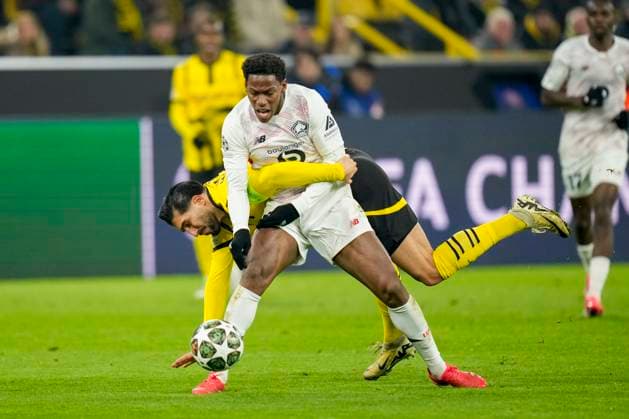Emre Can Borussia Dortmund and Jonathan David LOSC Lille battle for the ball during the UEFA Champions League 2024 25 Round of 16 First Leg match between Borussia Dortmund and LOSC Lille at Signal Iduna Park on March 4, 2025 in Dortmund, Germany