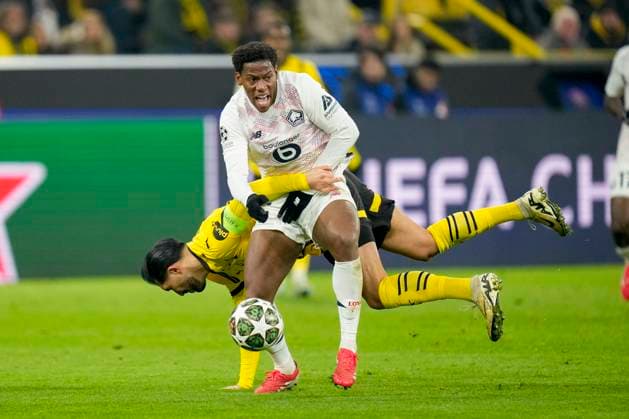 Emre Can Borussia Dortmund and Jonathan David LOSC Lille battle for the ball during the UEFA Champions League 2024 25 Round of 16 First Leg match between Borussia Dortmund and LOSC Lille at Signal Iduna Park on March 4, 2025 in Dortmund, Germany