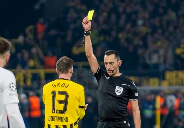 Yellow card for Pascal Gross Groß Borussia Dortmund, 13 by Jose Maria Sanchez Martinez Referee, Spain Borussia Dortmund vs OSC Lille, Football, UEFA Champions League, Round of 16, Season 2024 2025, 04 03 2025 DFL regulations prohibit any use of photographs as image sequences and or quasi video Copyright: HMBxMedia xMarcoxBader