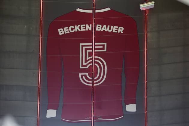 Football, Men, Champions League, Season 2024 2025, FC Bayern München Bayer 04 Leverkusen, Round of 16 first leg,Allianz Arena Here the jersey with the number 5, Franz Beckenbauer on the roof, inside of the Allianz Arena, above the south curve, souvenir, memorial