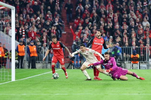 in duel, action, with Piero Hincapie 3 Bayer 04 Leverkusen , Mario Hermoso 5 Bayer 04 Leverkusen , Jamal Musiala 42 FC Bayern Muenchen , Matej Kovar 17 Bayer 04 Leverkusen , scores the goal for 2 0, FC Bayern Muenchen vs Bayer 04 Leverkusen, football, Champions League, round of 16, first leg, 05 03 2025 Muenchen Bayern Germany Copyright: xkolbert-press ChristianxKolbertx