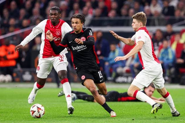 2025-03-06 AFC Ajax v Eintracht Frankfurt - UEFA Europa League 2024 25 Round of 16 First Leg AMSTERDAM, NETHERLANDS - MARCH 6: Jorthy Mokio of AFC Ajax battles for possession with Jean-Matteo Bahoya of Eintracht Frankfurt and Anton Gaaei of AFC Ajax during to the UEFA Europa League 2024 25 Round of 16 First Leg match between AFC Ajax and Eintracht Frankfurt at Johan Cruijff ArenA on March 6, 2025 in Amsterdam, Netherlands. Amsterdam Johan Cruijff ArenA Netherlands Content not available for redistribution in The Netherlands directly or indirectly through any third parties. Copyright: xBenxGalx