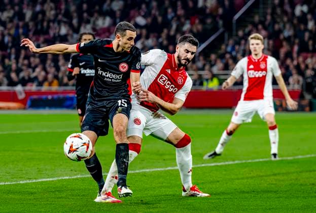 Eintracht Frankfurt midfielder Ellyes Skhiri, AFC Ajax Amsterdam defender Josip Sutalo during the match Ajax Eintracht at the Johan Cruijff ArenA for the UEFA Europa League Round of 16 1st leg season 2024 2025 in AMSTERDAM, Netherlands on 6 march 2025, photo by Marcel van Dorst EYE4images DeFodi Images
