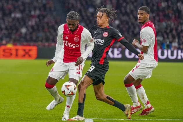 Football UEFA Europa League 2024 2025, round of 16 Ajax Amsterdam vs Eintracht Frankfurt Johan Cruijff ArenA Amsterdam, Netherlands Jorthy Mokio Ajax Amsterdam, 31 on the ball with Jean Matteo Bahoya Eintracht Frankfurt, 19 Copyright: xJOERANxSTEINSIEKx