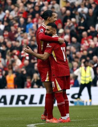 Football - 2024 2025 Premier League - Liverpool vs Southampton - Anfield - Saturday 8th March 2025 Mohamed Salah of Liverpool celebrates with Virgil van Dijk in front of the Kop after he scores his second penalty in the dying minutes to give Liverpool a 3-1 win, at Anfield. 