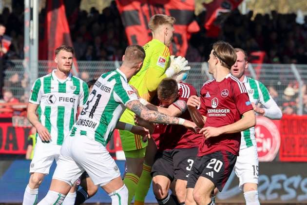 Holmbert Fridjonsson SC Preussen Muenster , Goalkeeper Jan Reichert 1 FC Nuernberg , Robin Knoche 1 FC Nuernberg and Caspar Jander 1 FC Nuernberg battle for the ball, 2 Bundesliga, Preußen Münster vs 1 FC Nürnberg, Preußenstadion on March 09, 2025 in Münster, Germany Photo by Marco Steinbrenner DeFodi Images Holmbert Fridjonsson SC Preussen Muenster , Goalkeeper Jan Reichert 1 FC Nuernberg , Robin Knoche 1 FC Nuernberg and Caspar Jander 1 FC Nuernberg battle for the ball, 2 Bundesliga, Preußen Münster vs 1 FC Nürnberg, Preußenstadion, March 9, 2025 in Münster, Germany Photo by Marco Steinbrenner DeFodi Images DFB DFL REGULATIONS PROHIBIT ANY USE OF PHOTOGRAPHS AS IMAGE SEQUENCES AND OR QUASI VIDEO