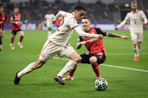 UEFA Champions League, Bayer 04 Leverkusen FC Bayern Munich 11 03 2025 Jamal Musiala FC Bayern Munich, 42 and Alejandro Grimaldo Bayer 04 Leverkusen, 20 in a duel UEFA Champions League, Bayer 04 Leverkusen FC Bayern Munich, round of 16, second leg, 11 03 2025 at BayArena in Leverkusen Copyright: xBEAUTIFULxSPORTS AxelxKohringx