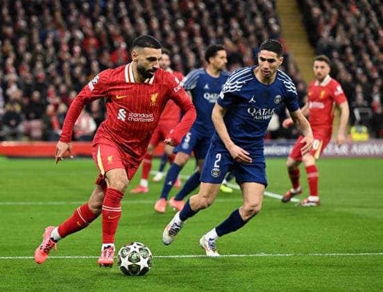 Liverpool, England, 11th March 2025. Mohamed Salah of Liverpool with Achraf Hakimi of Paris St Germain during the UEFA Champions League match Liverpool vs Paris Saint Germain at Anfield, Liverpool. Picture credit should read: Cody Froggatt Sportimage EDITORIAL USE ONLY. No use with unauthorised audio, video, data, fixture lists, club league logos or live services. Online in-match use limited to 120 images, no video emulation. No use in betting, games or single club league player publications. SPI_CF_027_Man_City_Real_Madrid SPI-3739-0027