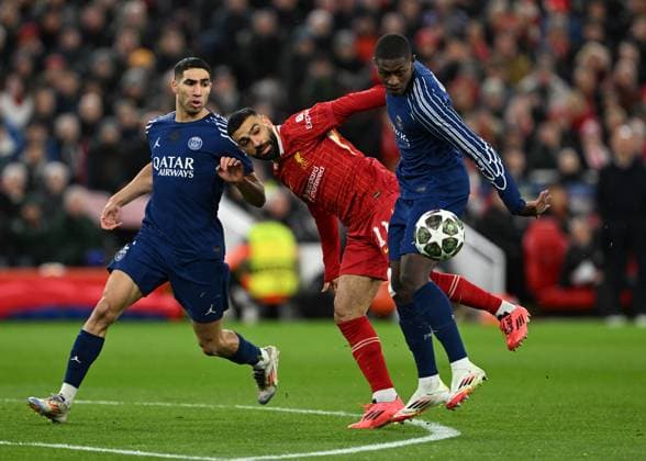 Liverpool, England, 11th March 2025. Mohamed Salah of Liverpool with William Pacho of Paris St Germain during the UEFA Champions League match Liverpool vs Paris Saint Germain at Anfield, Liverpool. Picture credit should read: Cody Froggatt Sportimage EDITORIAL USE ONLY. No use with unauthorised audio, video, data, fixture lists, club league logos or live services. Online in-match use limited to 120 images, no video emulation. No use in betting, games or single club league player publications. SPI_CF_030_Man_City_Real_Madrid SPI-3739-0030