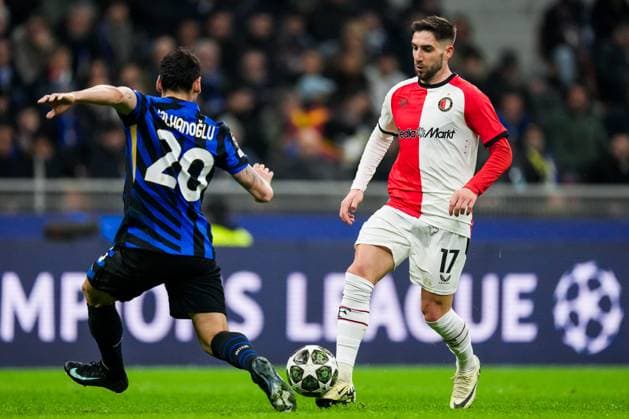 UEFA Champions League: FC Internationale Milan v Feyenoord Milan - Hakan Calhanoglu of FC Inter Milan, Luka Ivanusec of Feyenoord during the 2nd leg of the round of 16 of new format of the Champions League 2024 2025. The match is set between FC Internationale Milan and Feyenoord at Giuseppe Meazza San Siro on 11 March 2025 in Milan, Italy. Copyright: xTomxBodex