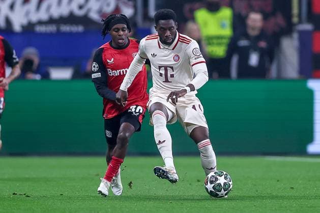 11 03 2025, Football, UEFA Champions League, Bayer 04 Leverkusen FC Bayern Munich, Round of 16 second leg, BayArena, Season 2024 2025 Jeremie Frimpong Bayer04 Leverkusen 30 in duel against Alphonso Davies FC Bayern 19 DFB regulations prohibit any use of photographs as image sequences and or quasi video Nordrhein Westfalen Germany