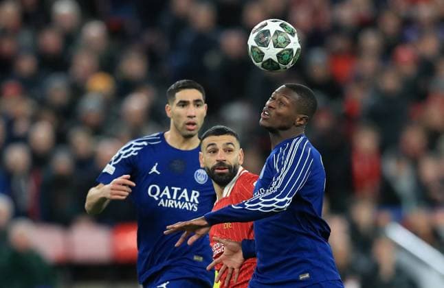11th March 2025; Anfield, Liverpool, Merseyside, England; Champions League Last 16, Second Leg Football, Liverpool versus Paris Saint Germain; Mohammed Salah of Liverpool competes for the ball with William Pacho of Paris Saint Germain  ActionPlus12758846 DavidxBlunsden