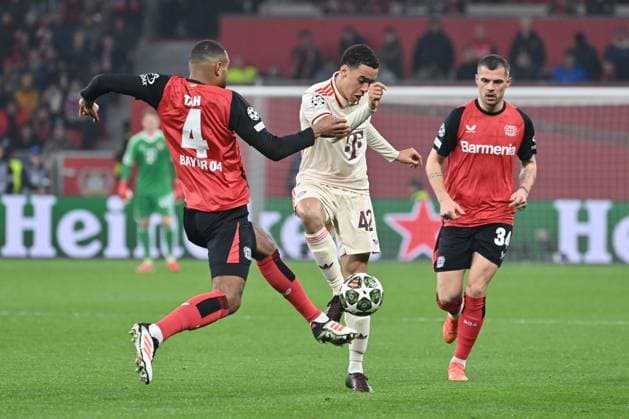 11 03 2025, xjrdrx, Football UEFA Champions League, Bayer 04 Leverkusen Bayern Munich v l Jonathan Tah Leverkusen, 4 , Jamal Musiala Muenchen, 42 duel, duel, fight, tackle DFL DFB REGULATIONS PROHIBIT ANY USE OF PHOTOGRAPHS as IMAGE SEQUENCES and or QUASI VIDEO Leverkusen