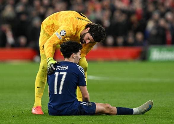 Liverpool, England, 11th March 2025. Alisson Becker of Liverpool speaks to Vitinha of Paris St Germain during the UEFA Champions League match Liverpool vs Paris Saint Germain at Anfield, Liverpool. Picture credit should read: Cody Froggatt Sportimage EDITORIAL USE ONLY. No use with unauthorised audio, video, data, fixture lists, club league logos or live services. Online in-match use limited to 120 images, no video emulation. No use in betting, games or single club league player publications. SPI_CF_053_Man_City_Real_Madrid SPI-3739-0053