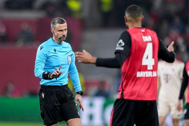 LEVERKUSEN, GERMANY - MARCH 11: referee Slavko Vincic, Jonathan Tah of Bayer 04 Leverkusen during the UEFA Champions League 2024 25 UEFA Champions League 2024 25 Round of 16 second leg match between Bayer 04 Leverkusen and FC Bayern MÃ¼nchen at the BayArena on March 11, 2025 in Leverkusen, Germany. (Photo by Rene Nijhuis) SPO  Copyright: xRenexNijhuis
