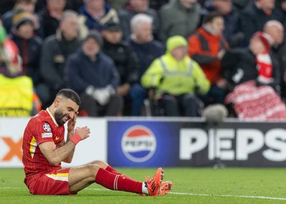 Liverpool v Paris Saint-Germain, UEFA Champions League, Round of 16, Second Leg, Football, Anfield, Liverpool, UK - 11 Mar 2025 Mo Salah of Liverpool FC sits on the pitch after Nuno Mendes of Paris Saint-Germain caught him in the face Anfield Liverpool GBR, UK NEWSPAPERS OUT Copyright: xEllixBirchx
