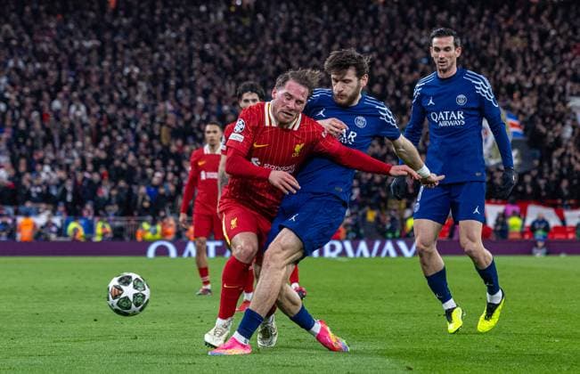 (250312) -- LIVERPOOL, March 12, 2025 -- Liverpool s Alexis Mac Allister (L) is challenged by Paris Saint-Germain s Khvicha Kvaratskhelia during the UEFA Champions League Round of 16 2nd Leg match between Liverpool FC and Paris Saint-Germain FC in Liverpool, Britain, on March 11, 2025. (SP)BRITAIN-LIVERPOOL-FOOTBALL-UEFA CHAMPIONS LEAGUE-LIVERPOOL FC VS PSG LixYing 