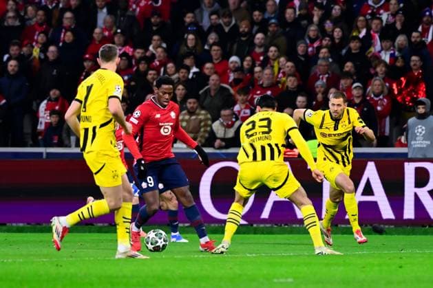 FOOTBALL : Lille vs Borussia Dortmund - Ligue des Champions - 12 03 2025 Jonathan David ( 9 - Lille ) , Emre Can ( 23 - Borussia Dortmund ) and Nico Schlotterbeck ( 4 - Borussia Dortmund ) during UEFA Champions League match between Lille OSC and Borussia Dortmund at Stade Pierre Mauroy on March 12, 2025 in Lille, France. ( Photo by Dante Badano PsnewZ ) - LilleFrance  Copyright: xDantexBadanox