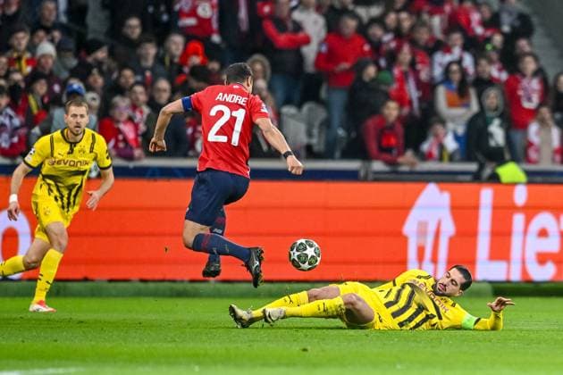 Lille, France, 12 03 2025 Benjamin Andre LOSC Lille and Emre Can BV Borussia Dortmund battle for the ball during the UEFA Champions League 2024 25 Round of 16 Second Leg match between LOSC Lille and Borussia Dortmund at Stade Pierre Mauroy on March 12, 2025 in Lille, France Photo by Harry Langer DeFodi Images