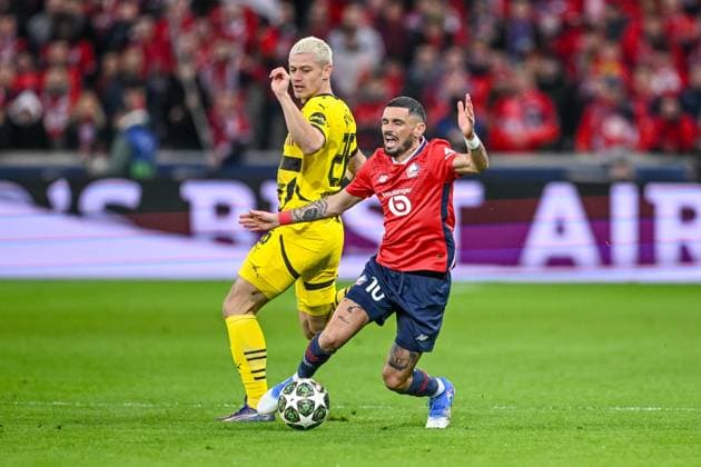 Lille, France, 12 03 2025 Julian Ryerson BV Borussia Dortmund and Remy Cabella LOSC Lille battle for the ball during the UEFA Champions League 2024 25 Round of 16 Second Leg match between LOSC Lille and Borussia Dortmund at Stade Pierre Mauroy on March 12, 2025 in Lille, France Photo by Harry Langer DeFodi Images