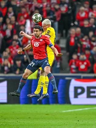 Lille, France, 12 03 2025 Benjamin Andre LOSC Lille and Julian Ryerson BV Borussia Dortmund battle for the ball during the UEFA Champions League 2024 25 Round of 16 Second Leg match between LOSC Lille and Borussia Dortmund at Stade Pierre Mauroy on March 12, 2025 in Lille, France Photo by Harry Langer DeFodi Images