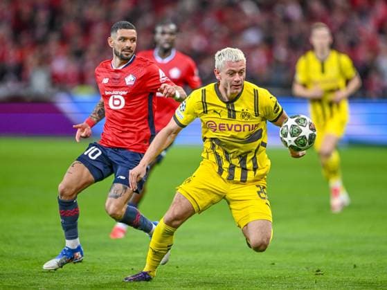 Lille, France, 12 03 2025 Remy Cabella LOSC Lille and Julian Ryerson BV Borussia Dortmund battle for the ball during the UEFA Champions League 2024 25 Round of 16 Second Leg match between LOSC Lille and Borussia Dortmund at Stade Pierre Mauroy on March 12, 2025 in Lille, France Photo by Harry Langer DeFodi Images