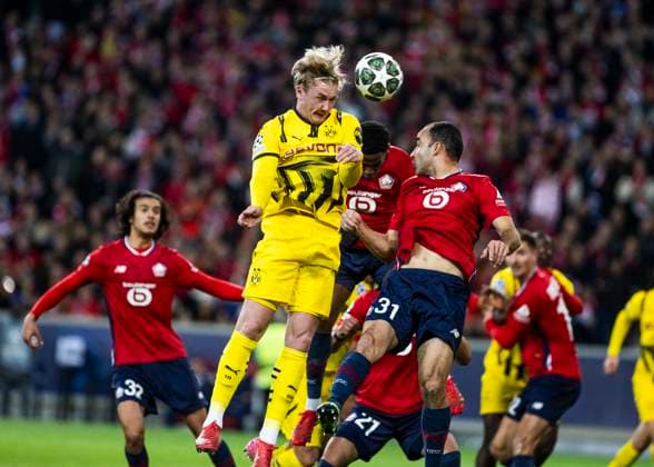 Lille, Stade Pierre Mauroy, 12 03 2025 Julian Brandt of Dortmund jumps for a header against Ismaily of Lille during the match of the Championsleague Round 16 between Lille OSC v Borussia Dortmund