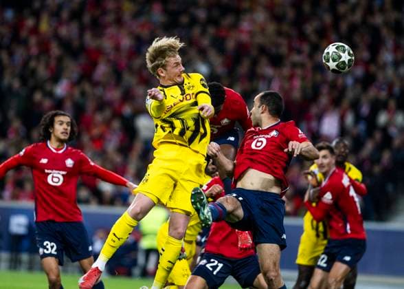 Lille, Stade Pierre Mauroy, 12 03 2025 Julian Brandt of Dortmund jumps for a header against Ismaily of Lille during the match of the Championsleague Round 16 between Lille OSC v Borussia Dortmund