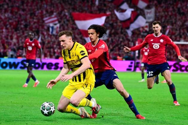 FOOTBALL : Lille vs Borussia Dortmund - Ligue des Champions - 12 03 2025 Aissa Mandi ( 2 - Lille ) and Nico Schlotterbeck ( 4 - Borussia Dortmund ) during UEFA Champions League match between Lille OSC and Borussia Dortmund at Stade Pierre Mauroy on March 12, 2025 in Lille, France. ( Photo by Dante Badano PsnewZ ) - LilleFrance  Copyright: xDantexBadanox